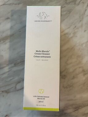 Drunk Elephant Facial Cleanser in Dark Gray Packaging with Lime Accents